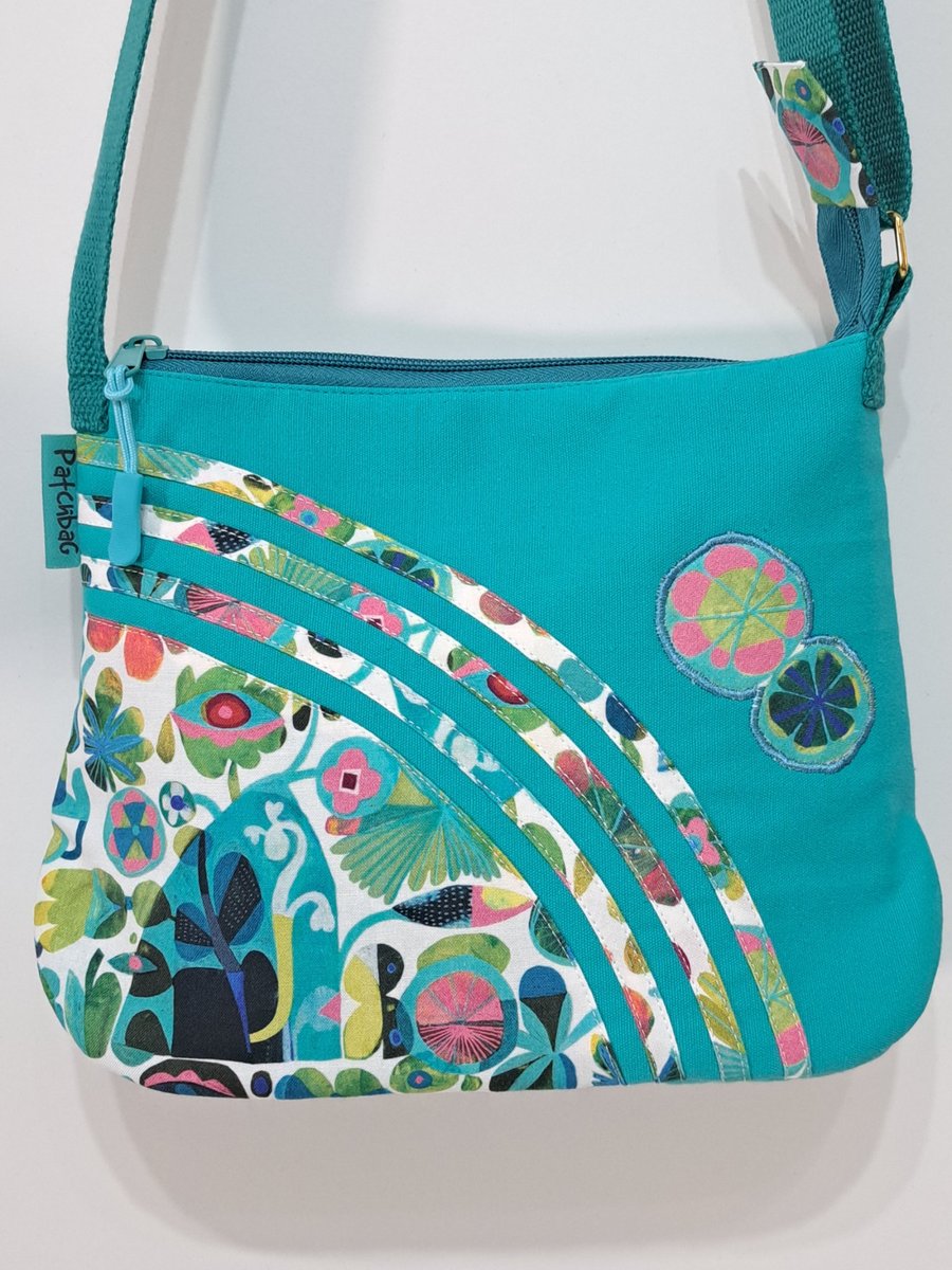 Small turquoise handbag with abstract flowers 