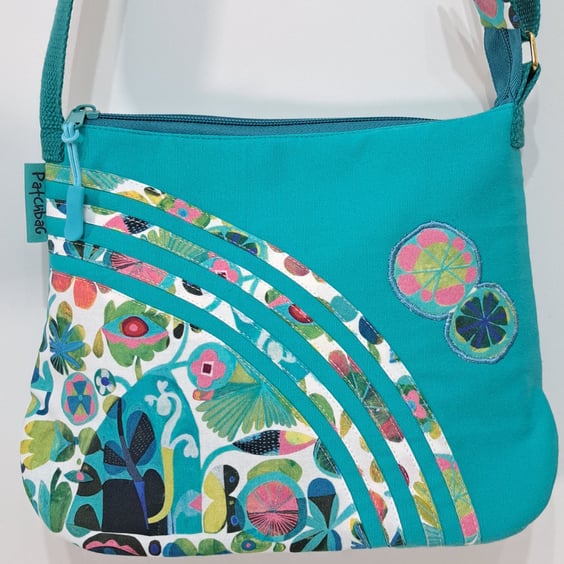 Small turquoise handbag with abstract flowers 