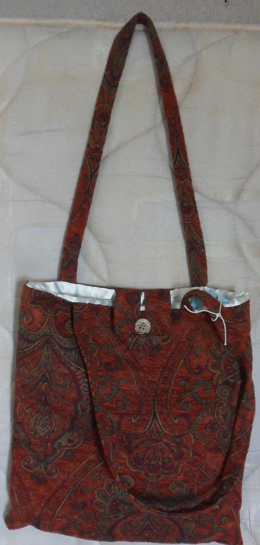 Homemade Toe bag. Red, orange design.  Approx measures 14 half" x 15 half"