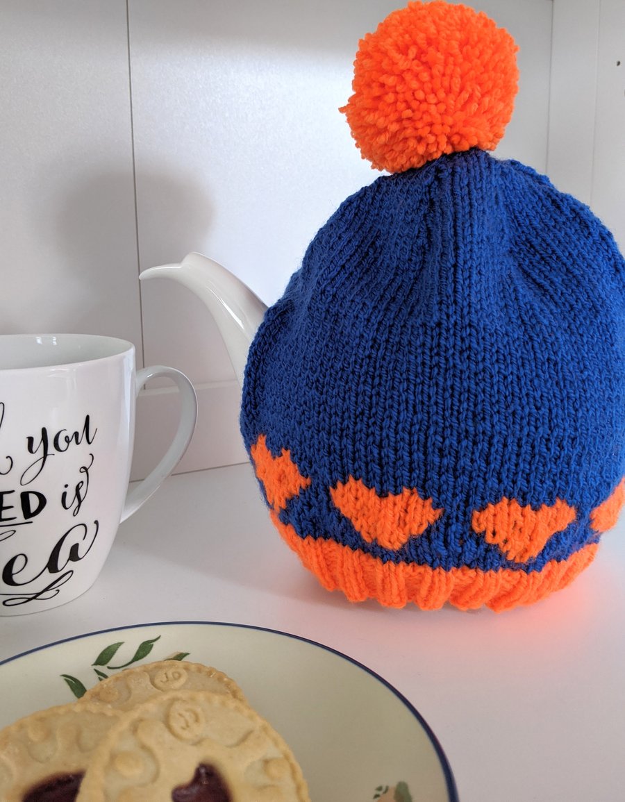 Knitted blue and orange tea cosy