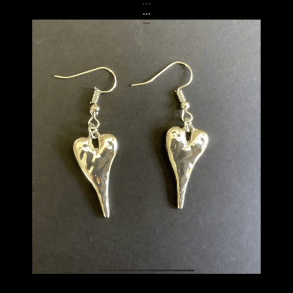 Pretty silver coloured hammered heart earrings. 