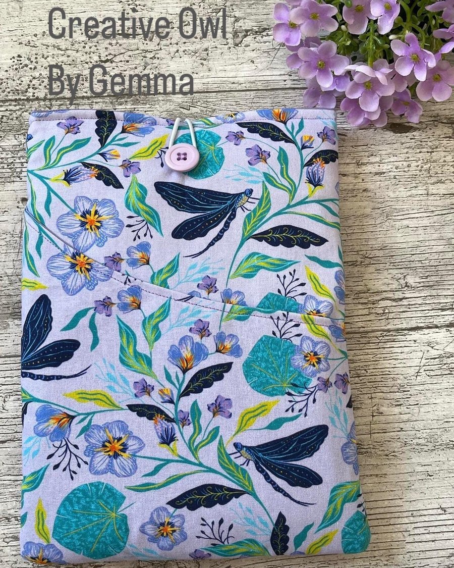 Fabric book sleeve with pocket for paperback books. Padded and fully lined. Hand