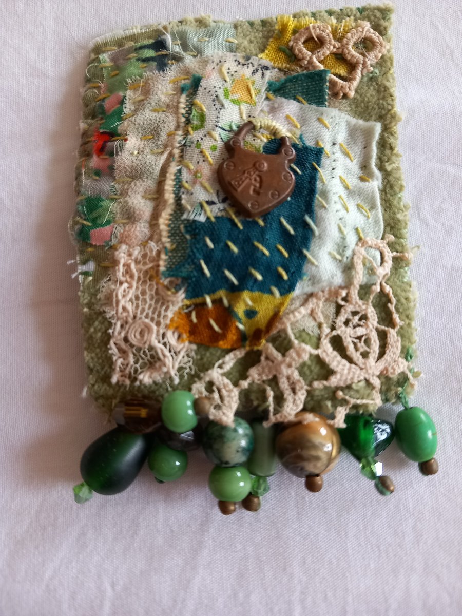 The green scrappy brooch
