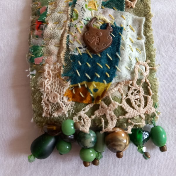 The green scrappy brooch