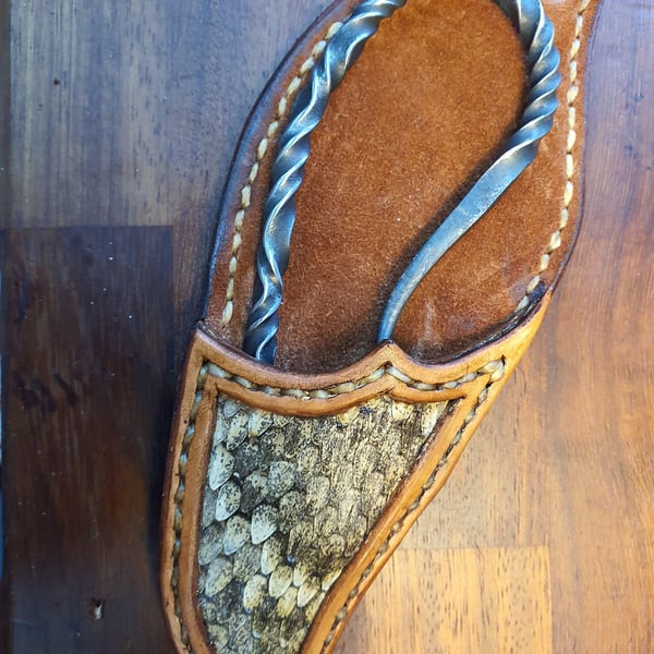 Bottle opener and leather sheath.