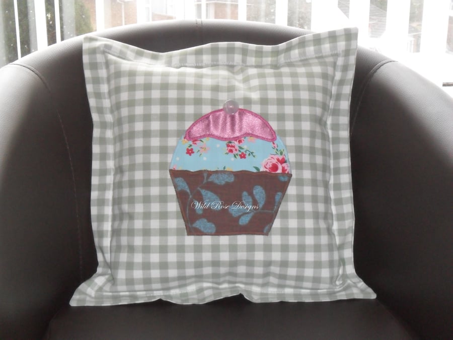 Cushions with appliqued cupcake. 