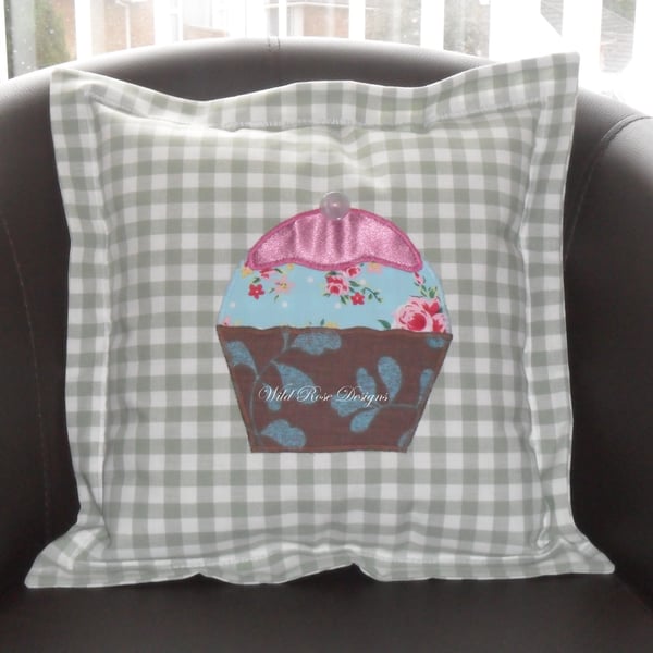 Cushions with appliqued cupcake. 