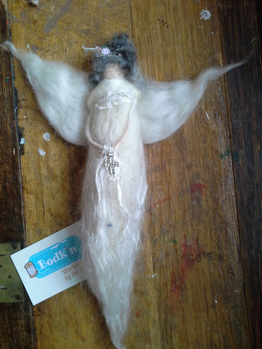 needle felted angel holding a cross 