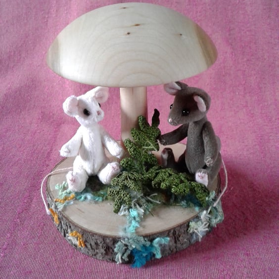 2 miniature mice, Button and Chestnut, under a mushroom 