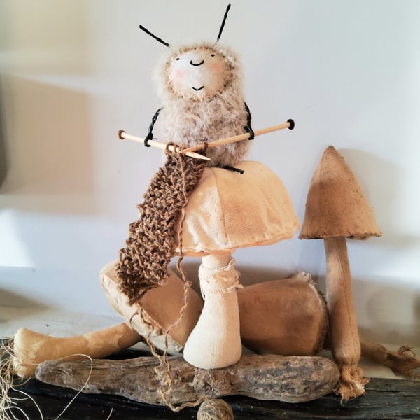 Mohair knitting bug on a linen mushroom soft sculpture