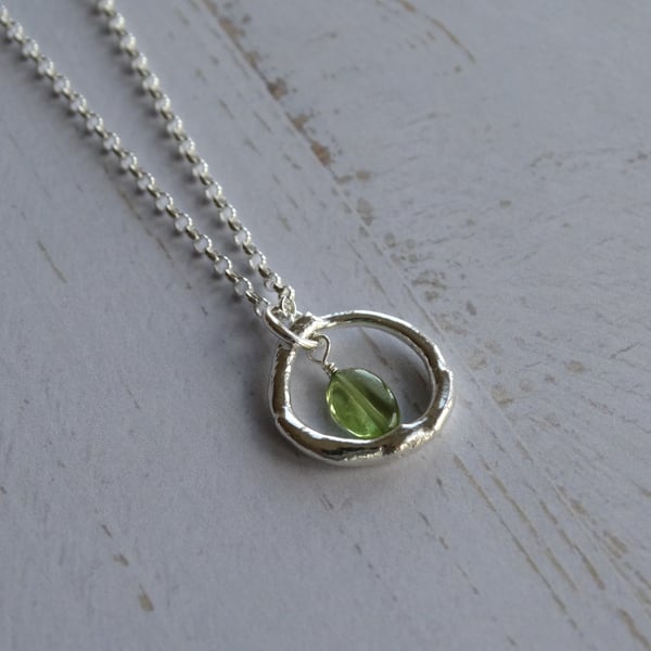 Silver and peridot hoop pendant - molten recycled sterling silver