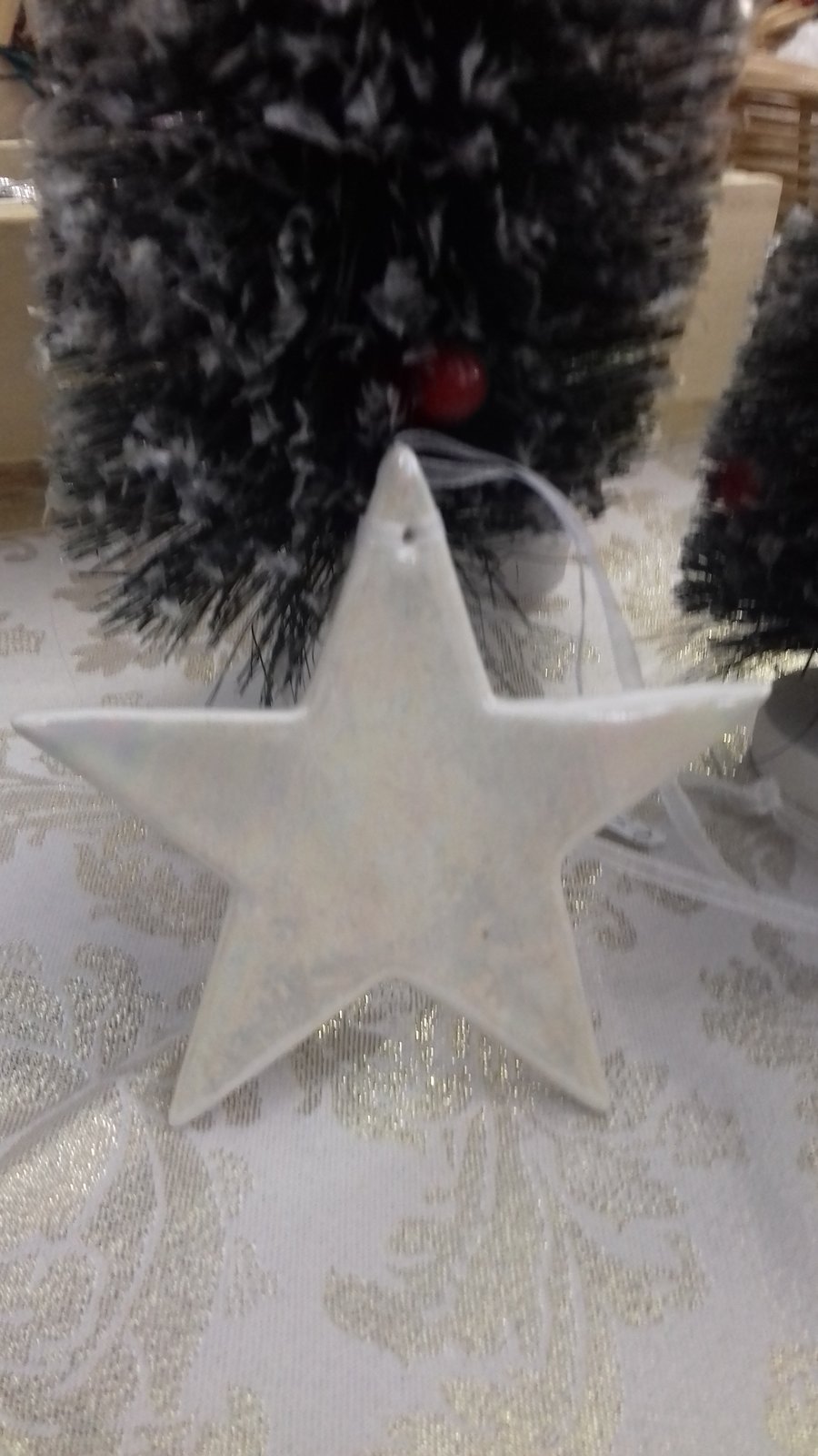 Handmade porcelain paper clay star hanging decoration with mother of pearl lustr