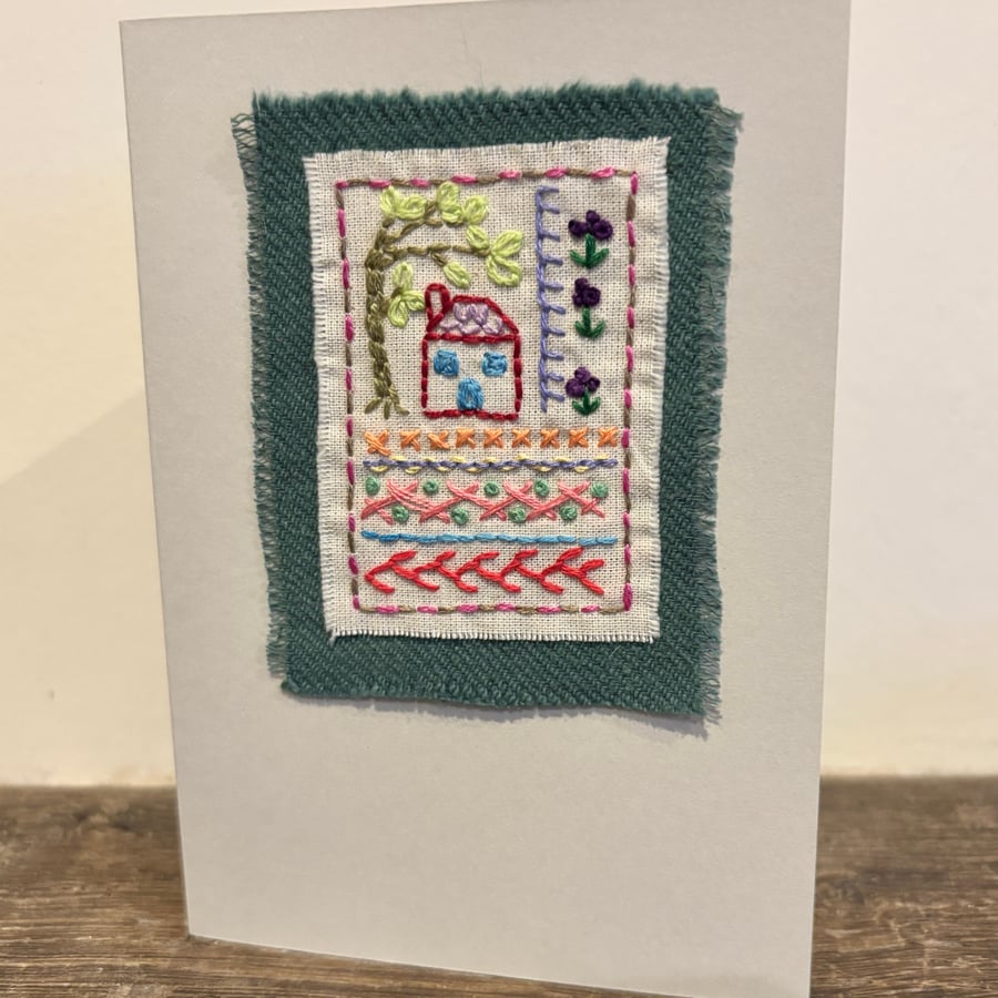 Handmade card sampler embroidery with a house, tree and flowers