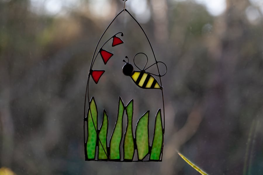 Bee over a flowering meadow stained glass suncatcher