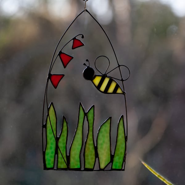 Bee over a flowering meadow stained glass suncatcher