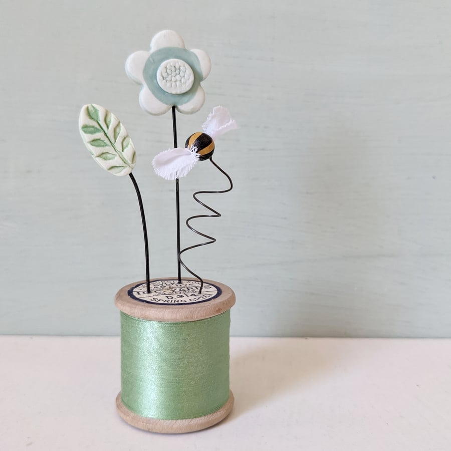 Clay Flowers and Bee on a Vintage Bobbin