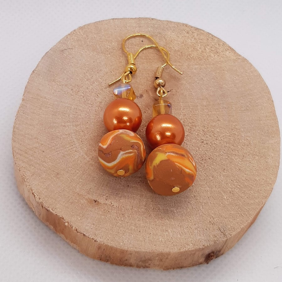 Dangly polymer clay earrings in orange, sienna and cream