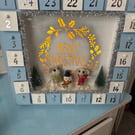 Wooden advent calendar with mice building snowman 