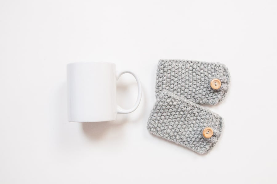 Pair of knitted mug cosies, cup cosy, coffee cosy in grey. Coffee mug cosy