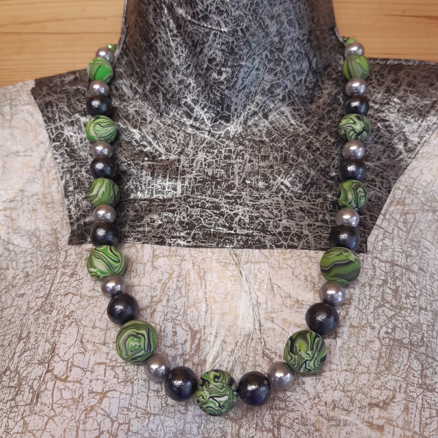 Bright green and black swirly patterned necklace