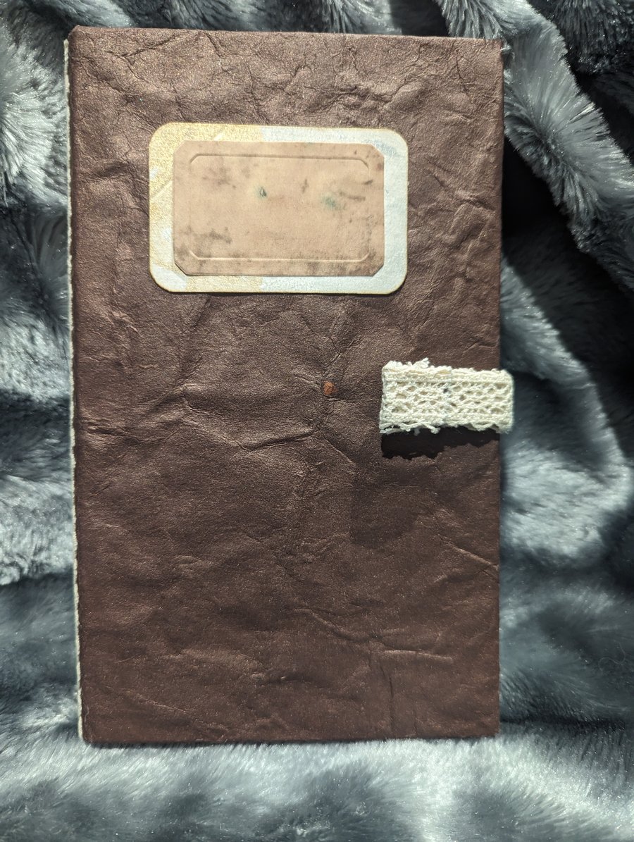 Brown handmade paper covered journal with lace spine