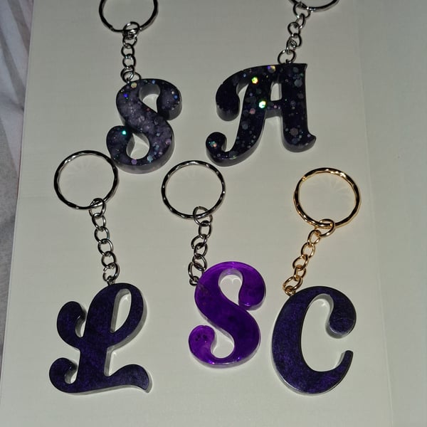 Purple handmade epoxy resin keyrings with initial letter