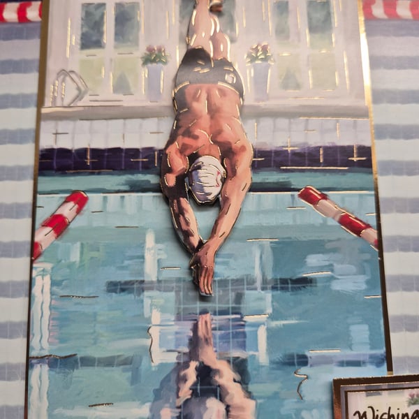 Male swimmer, diving into a swimming pool 