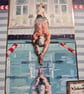 Male swimmer, diving into a swimming pool 