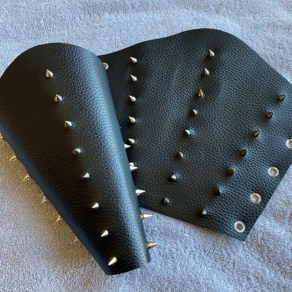 Large pair of black leather bracers with 3 rows of gold coloured spikes