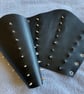 Large pair of black leather bracers with 3 rows of gold coloured spikes