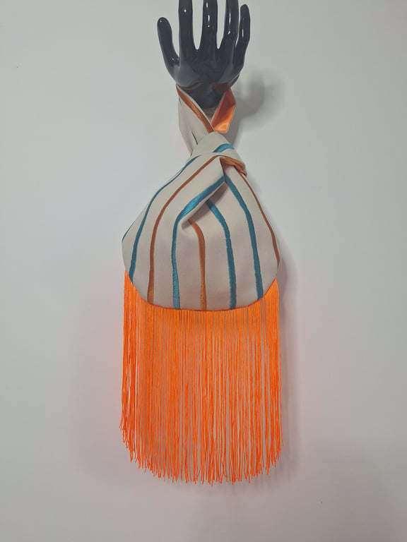Eye-catching striped patterned Japanese Knot bag with orange 19cm tassel trim.