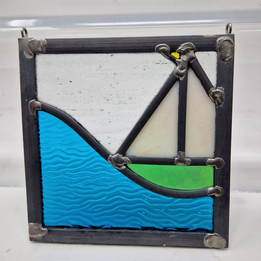 Stained glass iridescent green sailing boat and wave leaded hanging panel.
