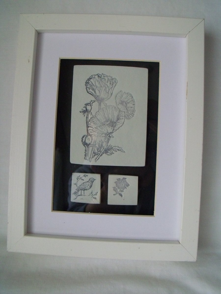 clay tiles with flowers and bird related images in a boxed frame, 9 x 7 inches