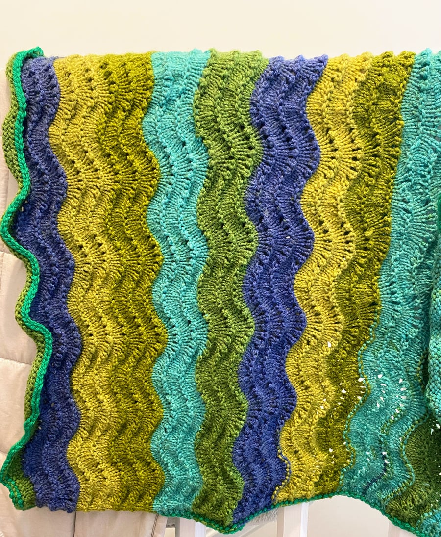 Knitted baby blanket blue and green waves
