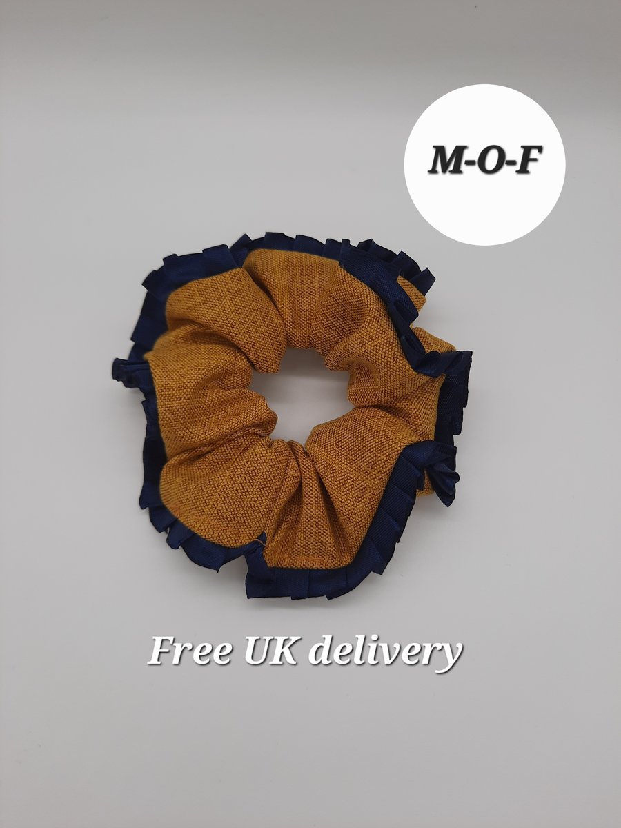 Mustard yellow scrunchie with navy pleated ribbon edging. 