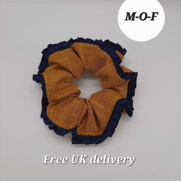 Mustard yellow scrunchie with navy pleated ribbon edging. 