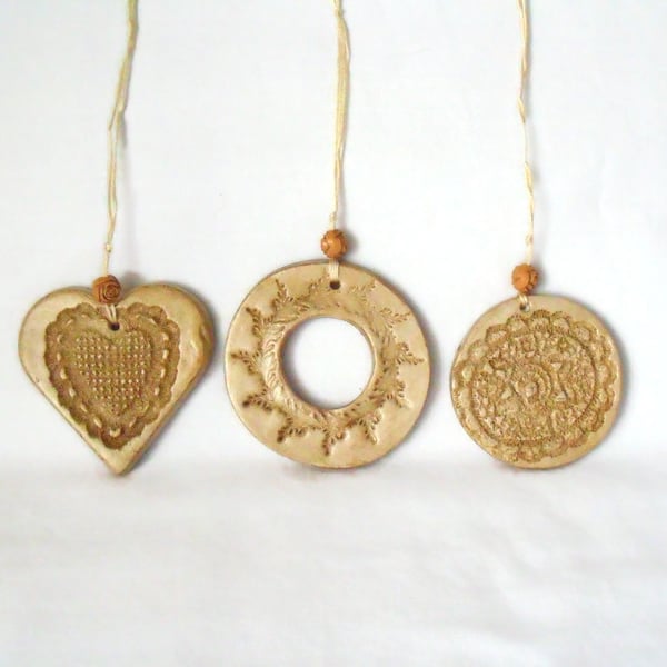 set of three impressed ceramic hanging decorations in beige