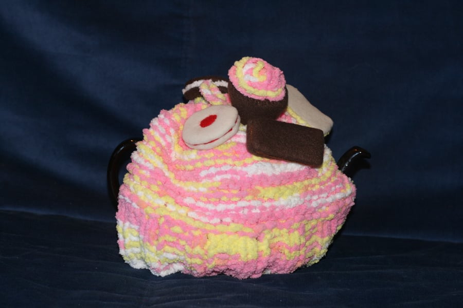 Hand knitted tea cosy with felt biscuits and cakes