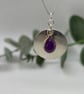 Silver disc pendant with amethyst