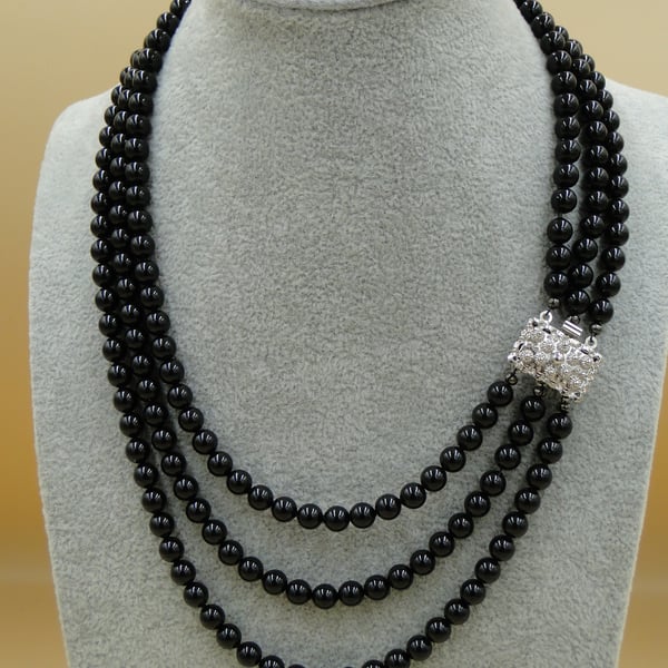 Elegant multi row Mystic black pearl necklace with sterling clasp.