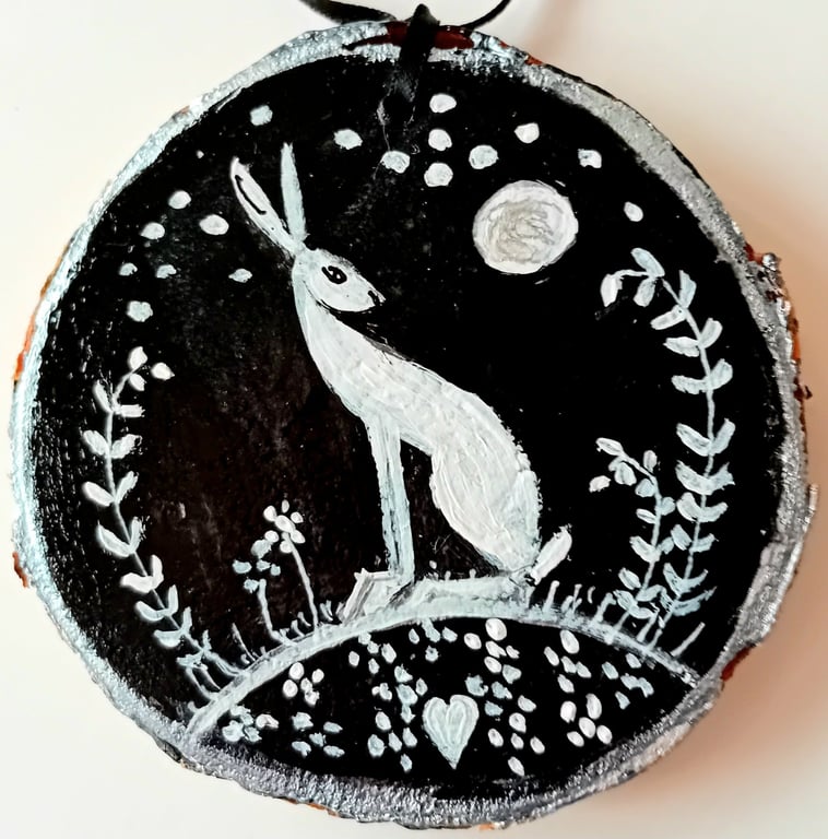 white hare on wood slice black background