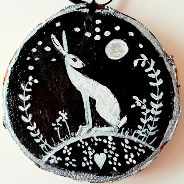 white hare on wood slice black background
