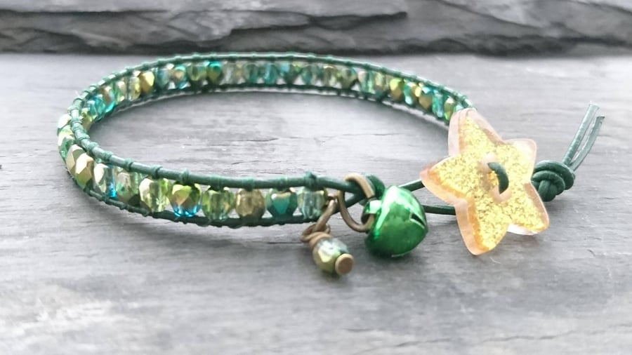 Green and gold leather and bead bracelet with glittery star button and bell