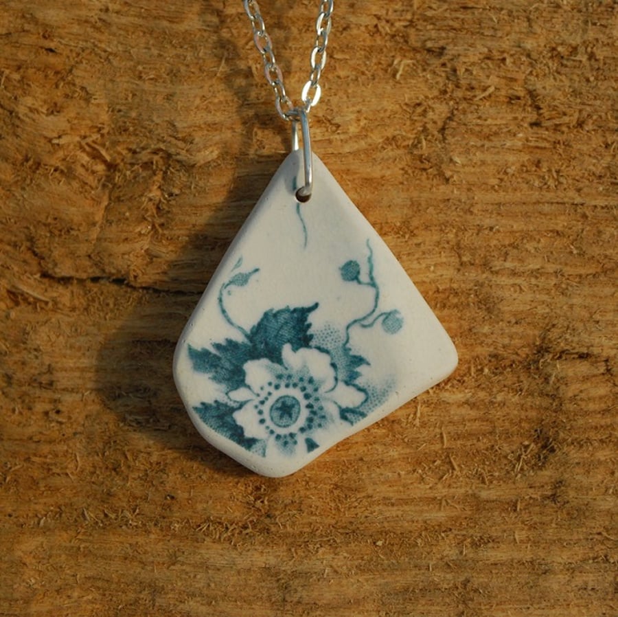 Beach pottery pendant with a green flower