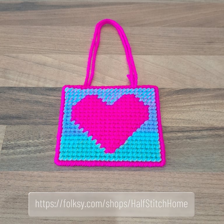 Wall art of a bright pink heart, adjustable hang length