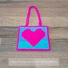 Wall art of a bright pink heart, adjustable hang length