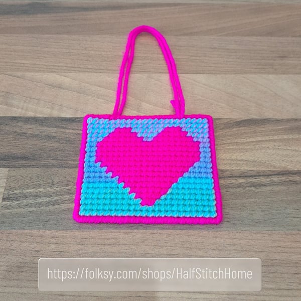 Wall art of a bright pink heart, adjustable hang length