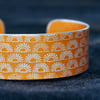 Geometric half sun pattern cuff bracelet orangey yellow