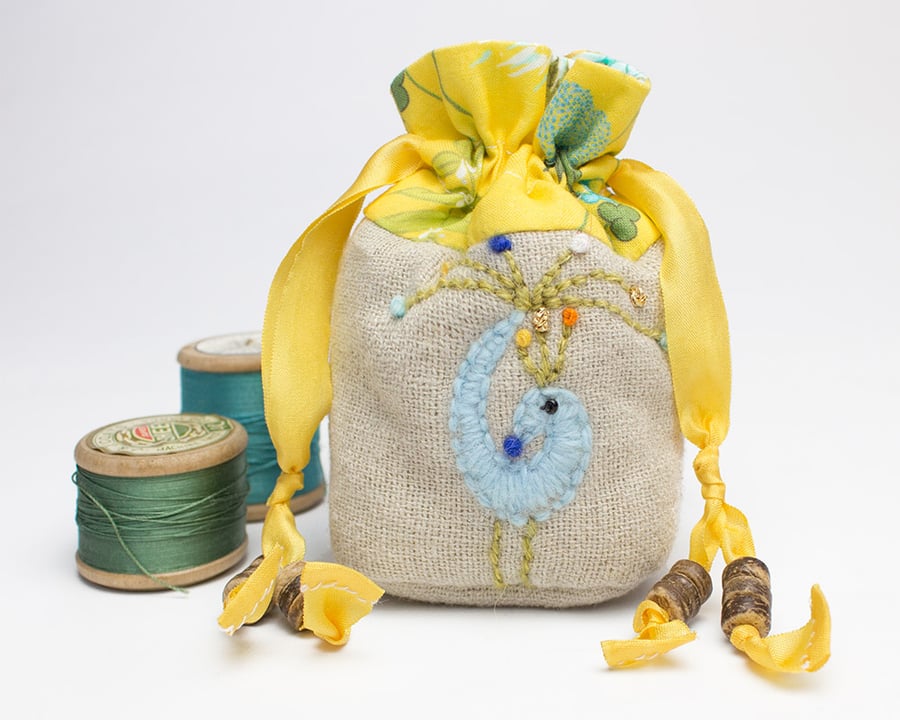 Miniature oatmeal linen drawstring bag with hand embroidered peacock