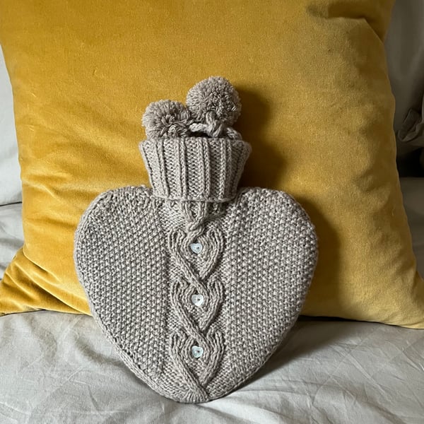 Heart shaped hot water bottle with hand knit cover